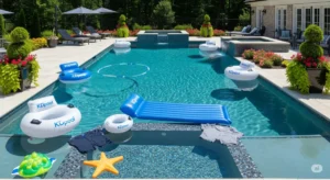 A featured image for a blog post exploring the cost of a new swimming pool, with no visible faces, showcasing KDpool attire in some areas. The photograph features a stunning, high-definition image of a large, sparkling pool in a luxurious backyard setting. A variety of KDpool-branded floats and pool toys are strategically placed in the pool and on the surrounding deck. The pool is designed with sleek, modern lines and features a beautiful mosaic tile surface. The surrounding landscape is immaculately maintained, with lush green plants and blooming flowers. The image conveys a sense of tranquility and luxury, perfect for a blog post about the cost of a new swimming pool. The camera angle is slightly elevated, providing a wide view of the entire pool area and surroundings, without showing any faces. The composition emphasizes the pool's aesthetic appeal and functionality, without distracting elements, creating an image that is both inviting and informative, perfect for promoting a post on pool construction.